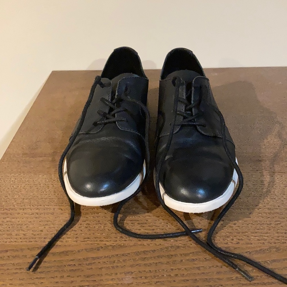 Women’s black lace-up oxfords with cream-colored soles